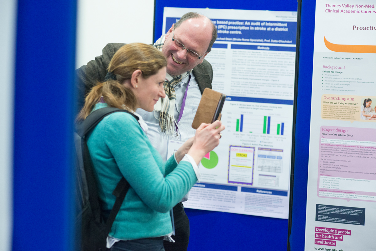 Resident doctor and consultant browsing posters