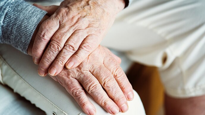 Older persons hands clasped